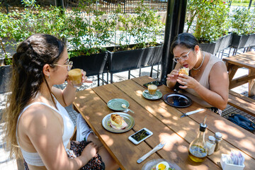 mother and daughter having breakfast on a weekend in a restaurant