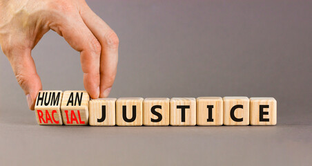 Racial or human justice symbol. Concept words Racial justice Human justice on wooden cubes. Beautiful grey background. Businessman hand. Ecological racial or human justice concept. Copy space. - obrazy, fototapety, plakaty