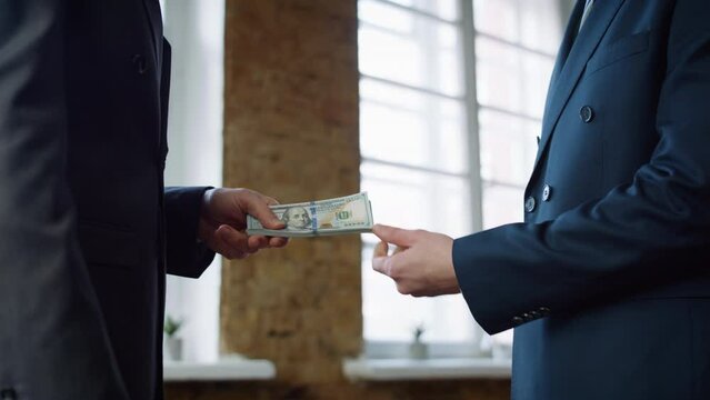 Businessman giving money partner at office meeting close up. Man receiving bribe