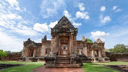 Fototapeta na wymiar A tourist walk to Prasat Muang Tam historical park at Buriram Province, Thailand. Khmer castle architecture in fantastic archaeological site from thousand years ago.