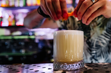 man hand bartender making white cocktail in glass on the bar counter
