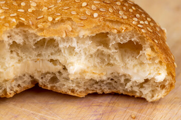 Wheat bun with large pieces of processed cheese inside