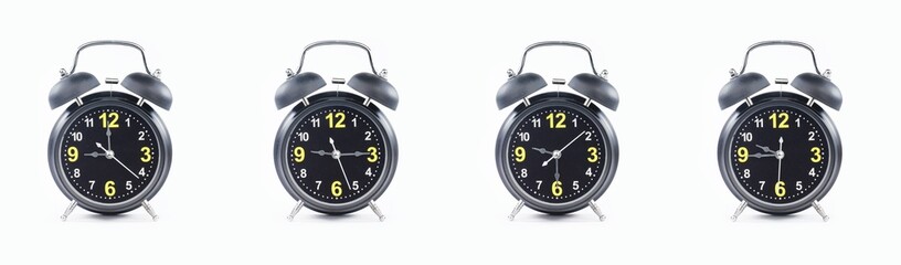 close up of a set of black alarm clocks showing the time; 9, 9.15, 9.30 and 9.45 p.m dan a.m. Isolated on white background - obrazy, fototapety, plakaty