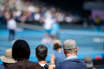 tennis fan watching a tennis match at the australian open eating food and drinking