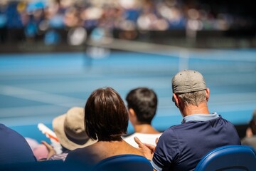 tennis fan watching a tennis match at the australian open eating food and drinking