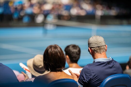 Tennis Fan Watching A Tennis Match At The Australian Open Eating Food And Drinking