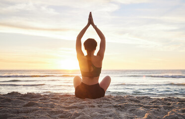 Woman, yoga and meditation on the beach sunset for zen workout or spiritual wellness outdoors....