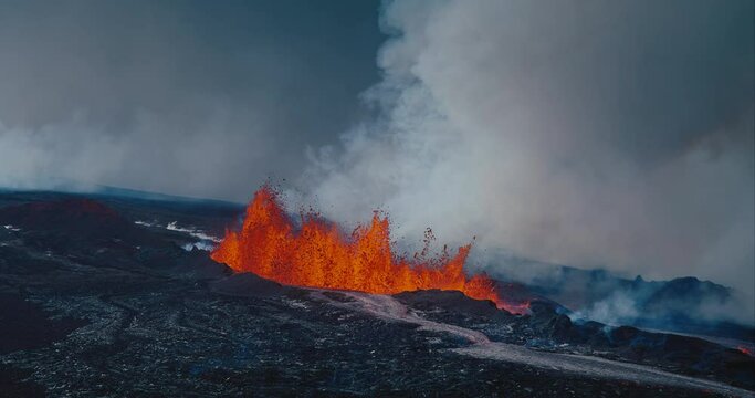 Hawaii Mauna Loa Volcano erupting molten hot lava, aerial view from helicopter