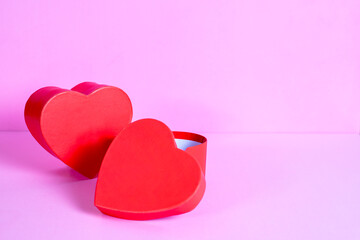 two red hearts in love on pink background