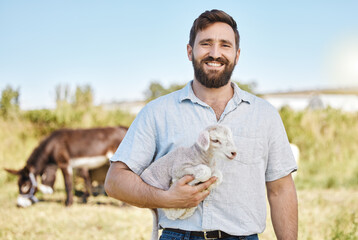 Farmer, portrait or baby lamb on livestock agriculture, countryside environment or nature in sheep growth management. Happy, farming or man and mutton animals, pet safety or veterinary life insurance © K Davis/peopleimages.com