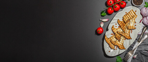 Fried slices Pleurotus eryngii mushrooms with balsamic sauce and sesame seeds. Spices and herbs