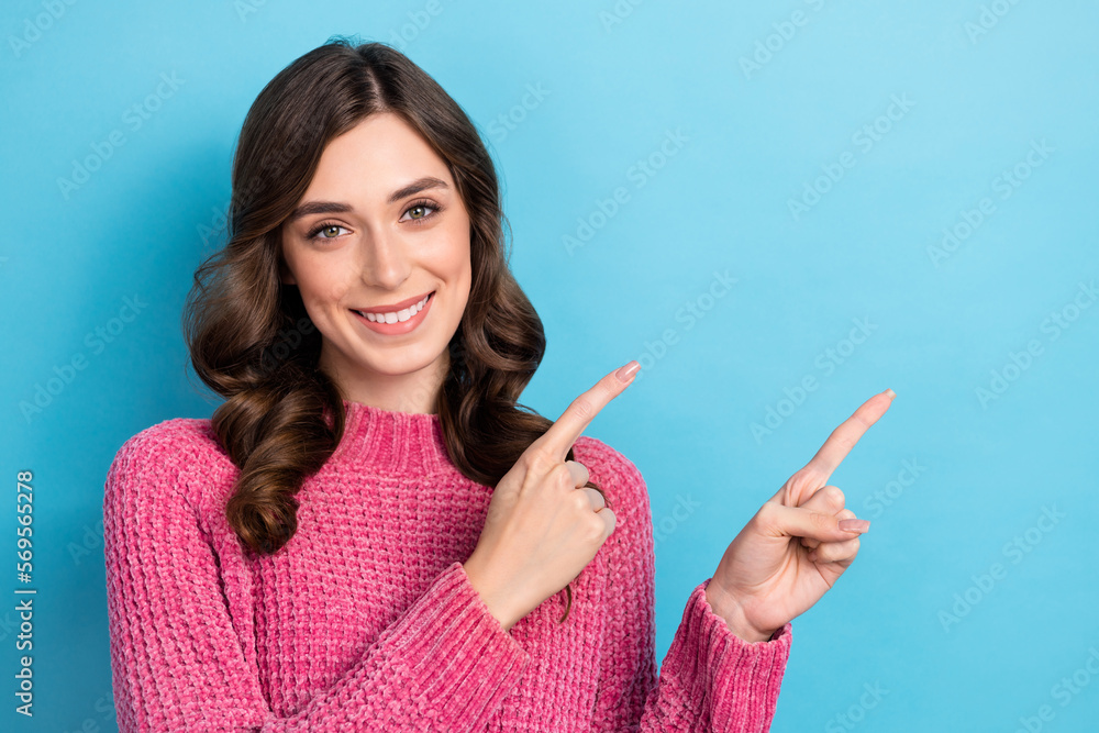 Wall mural Photo of positive lovely lady wear pink trendy clothes two arm presenting empty space banner isolated on blue color background