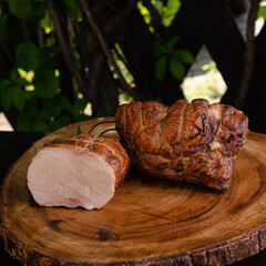 cut piece of ham close-up on a wooden board