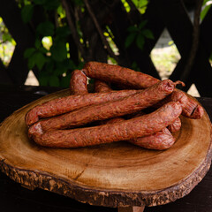 smoked hunting sausages on a wooden board close-up