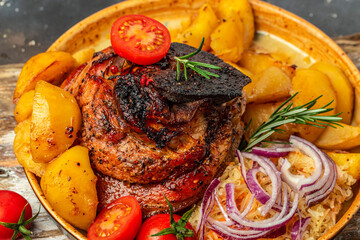 roasted pork leg with fried potatoes, Food recipe background. Close up