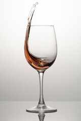 Splash of rose wine in glass, frozen motion