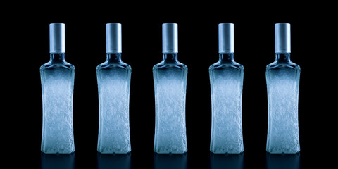 Frozen bottle of vodka covered with frost, close-up isolated on black - obrazy, fototapety, plakaty