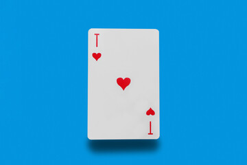 Playing cards ace of hearts on a blue background