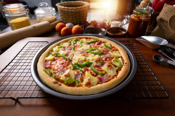 Top view of fresh baked homemade pizza on wooden table with ingredients and spices. Delicious Italian pizza is ready for deliver. Hawaiian Pizza with bell pepper bacon and pineapple.