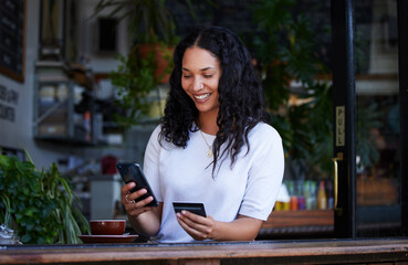 Woman, phone and credit card with smile for ecommerce, online shopping or purchase at coffee shop. Happy female shopper on smartphone for internet banking, app or wireless transaction at indoor cafe