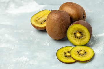 golden kiwi slices on a light background, banner, menu, recipe place for text, top view