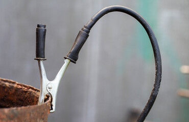 Welding terminal clamp in the welding cable for earth. Close-up, industry