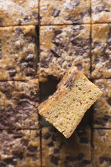 Top view of blondies with chocolate chunks, cross section of cut blondie bars