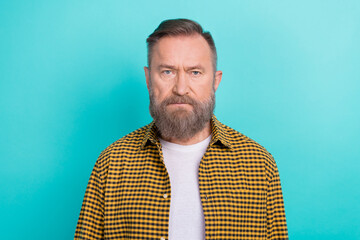 Closeup photo portrait of middle aged serious grimace face man grey beard wear yellow plaid shirt...