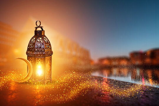 Ornamental Arabic lantern with burning candle glowing . Festive greeting card, invitation for Muslim holy month Ramadan Kareem. Ramadan Kareem greeting photo with serene mosque background.
