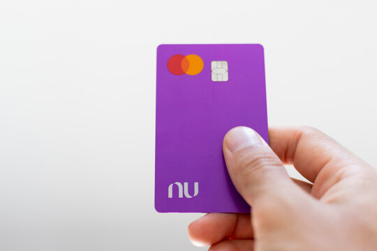 February 07, 2023, Brazil. Man Holding Nubank Credit Card ready to pay