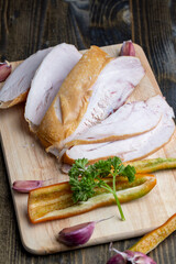 Smoke-smoked chicken is cut up on a board