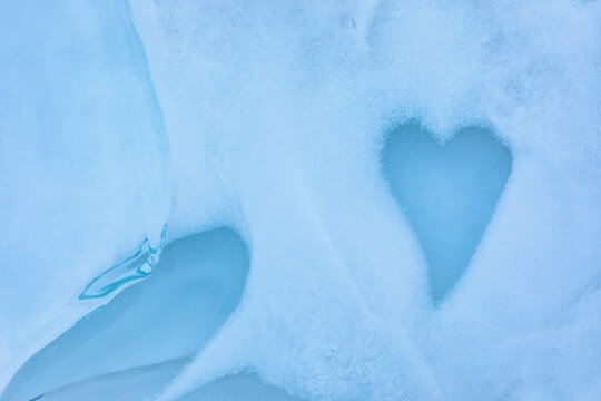 Heart melt in snow on icy lake