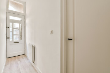 Narrow corridor with front door in house