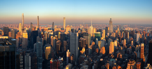 New York City aerial view of midtown Manhattan skyscrapers in warm light of sunset. An elevated...