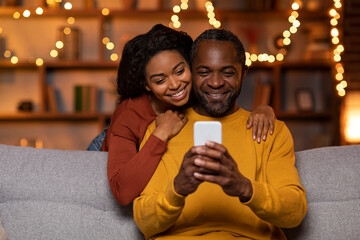 Loving african american spouses taking photo on phone