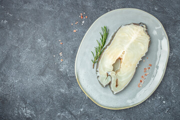 Raw steak of white Anarhichas fish sreak. banner, menu, recipe place for text, top view