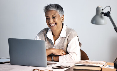 Senior business woman, laptop and office desk while happy about online communication or networking....