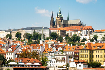 Prague Castle panorama, view from Smetanovo Waterfront over the Vltava river towards the Castle with Na kampe and other buildings in the foreground

