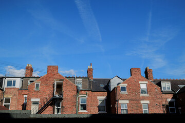 Jesmond UK: 21st Aug 2022: A row of terraced houses in Newcastle Jesmond with copy space and blue sky. Tyneside Flat style