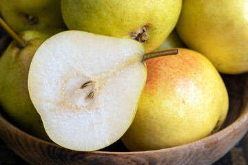 A yellow ripe pear with a red side on the table