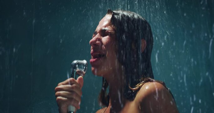 Authentic Shot of Carefree Woman Standing in a Shower, Listening to Music, Singing Along. Female Under Running Water Having a Spontaneous Moment, Pretending to be a Performing Singer 