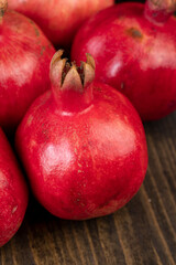 A small ripe red pomegranate is lying on the table