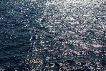 Very nice sea water background or backdrop with selective focus. Small waves of natural water surface texture.