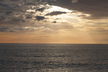 Calm sea with sunset sky and sun through the clouds over. Meditation ocean and sky background. Tranquil seascape.