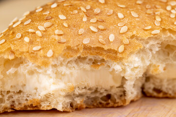 Wheat bun with large pieces of processed cheese inside