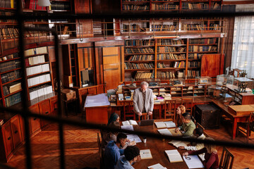 Professor having class in campus library.