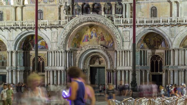 Entrance to Basilica of St Mark night timelapse. It is cathedral church of Roman Catholic Archdiocese of Venice. It located at Piazza San Marco. Tourists walking in front of it. Venice, Italy