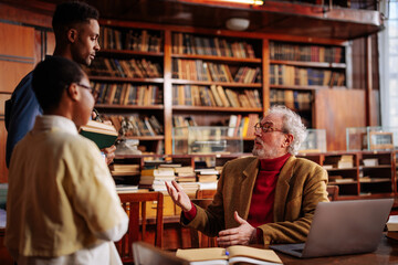 Graduate students consulting professor.