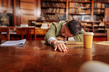 Fototapeta na wymiar Student sleeping in library.