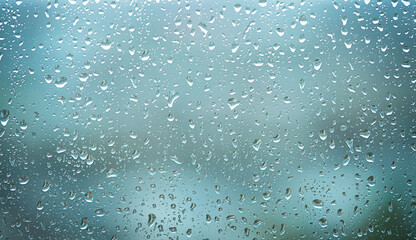 Raindrops on the window. Abstract blue background